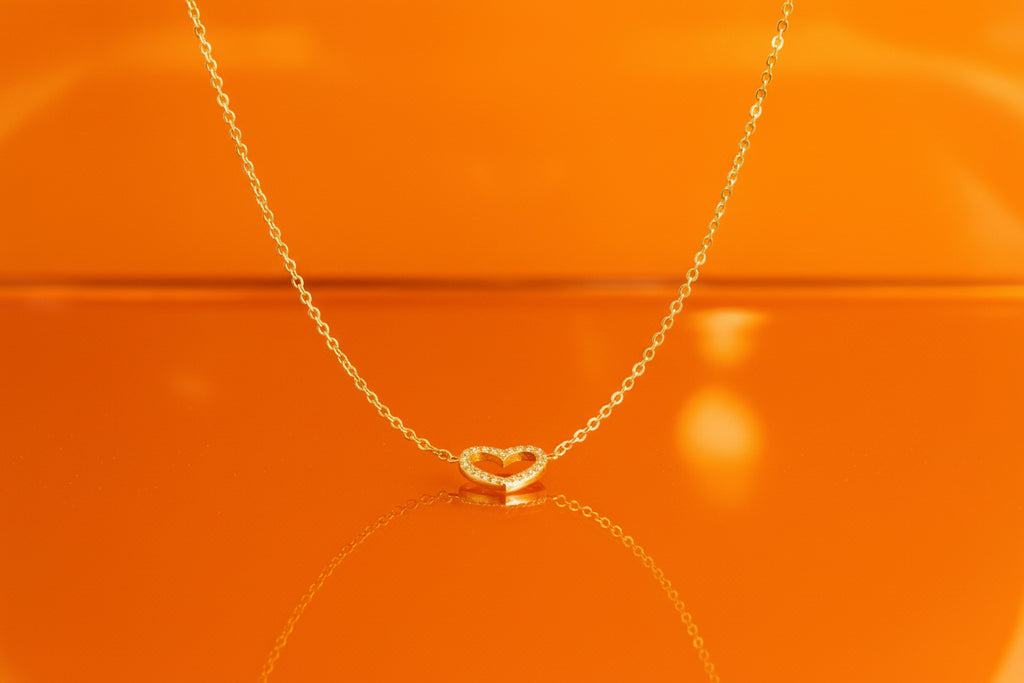 Kette mit herzanhänger Hintergrund leuchtendes orange
